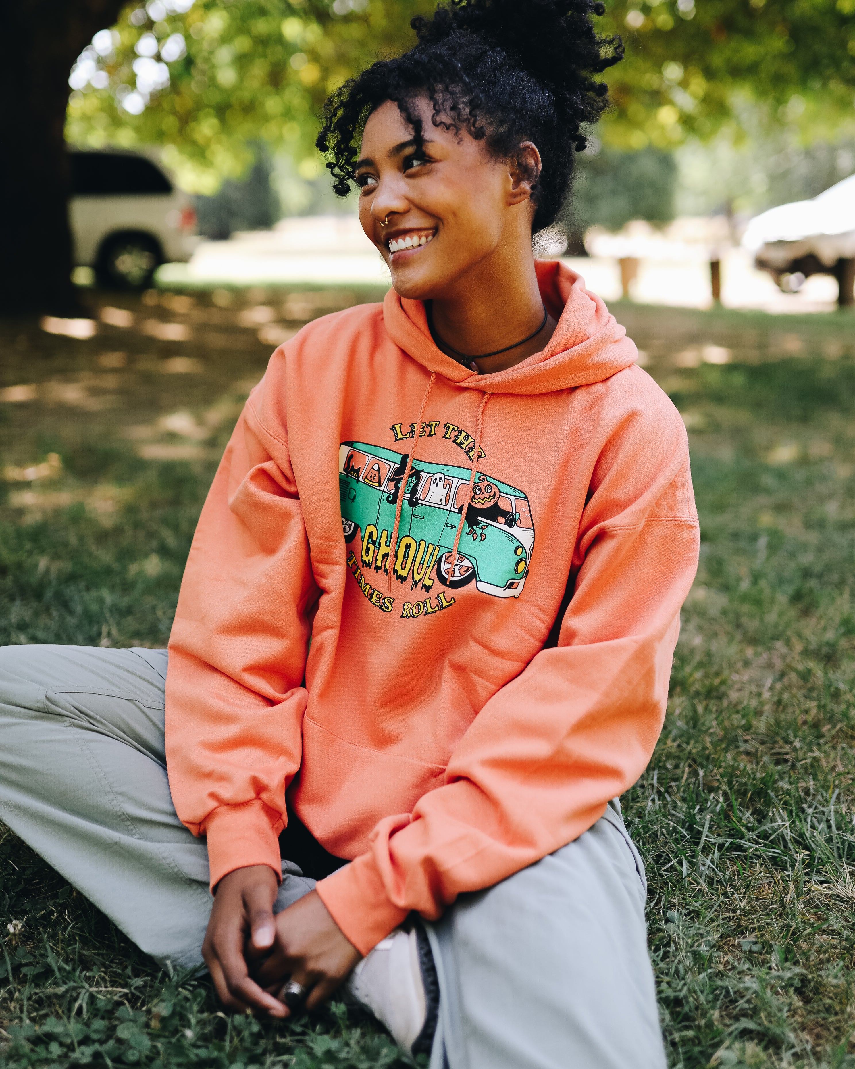 Model is 5'9 wearing Let the Ghoul Times Roll Halloween Hooded Sweatshirt size Large in Orange.